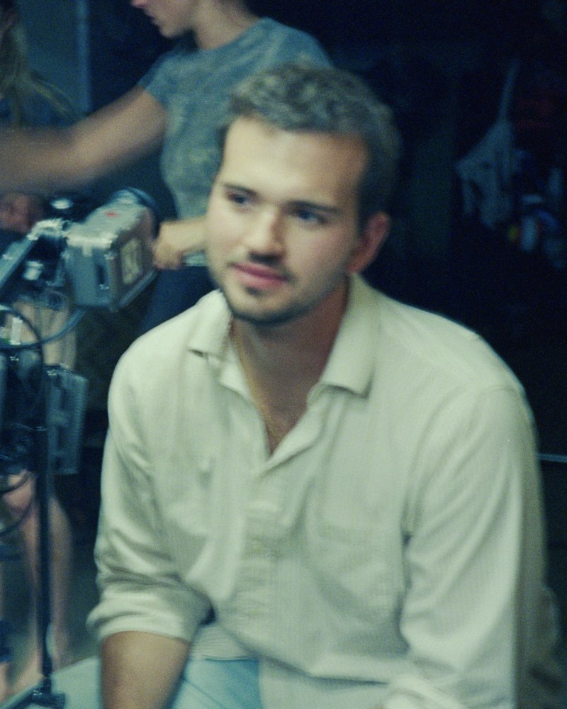 Arman Meinecke, director of photography, on set beside the camera